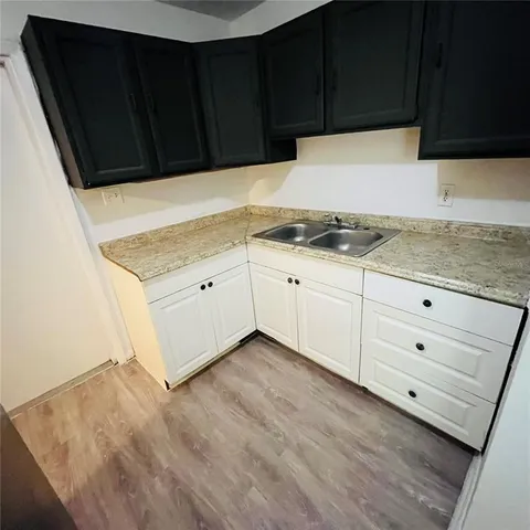 a kitchen with granite countertop cabinets and sink