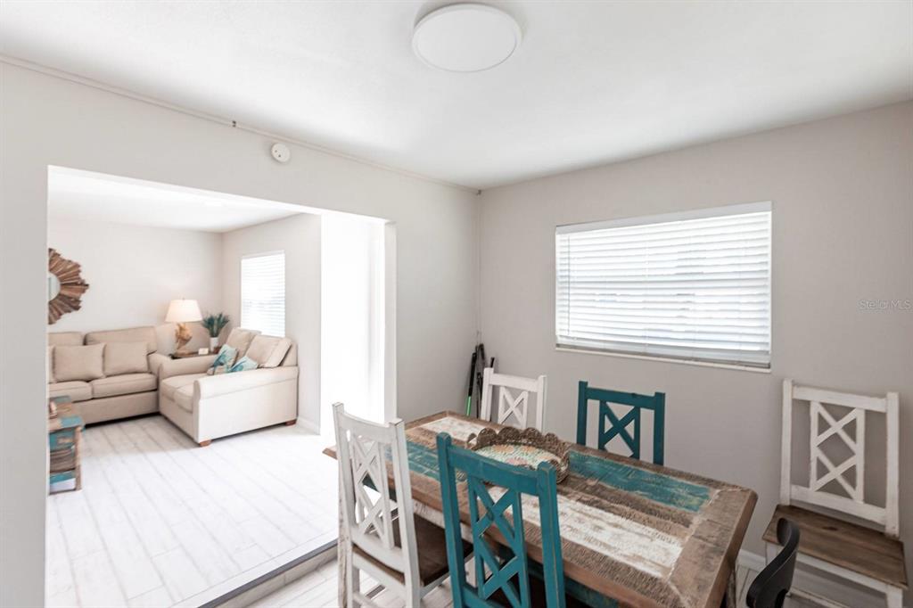 6020 Midnight Pass Road, Unit 52A Sarasota, FL 34242 - Photo 12 of 28 a living room with furniture and a window
