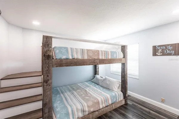 a bedroom with a bed and a chandelier