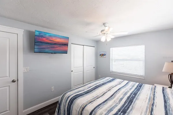 a bedroom with a bed and a flat screen tv