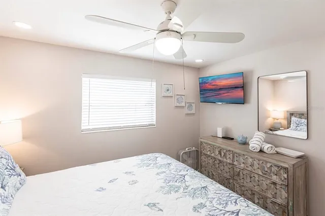 a spacious bedroom with a bed and a chandelier