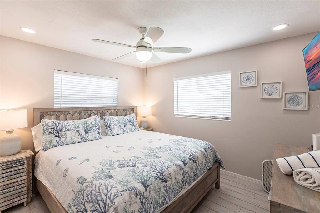 6020 Midnight Pass Road, Unit 52A Sarasota, FL 34242 - Photo 23 of 28 a bedroom with a large bed and a window