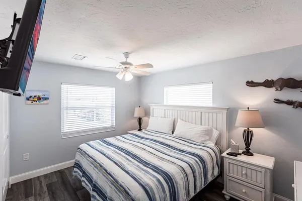 a living room with a bed and a book shelf