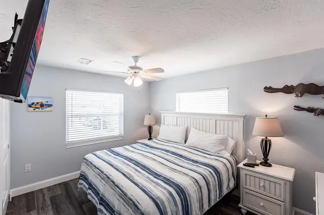 a living room with a bed and a book shelf