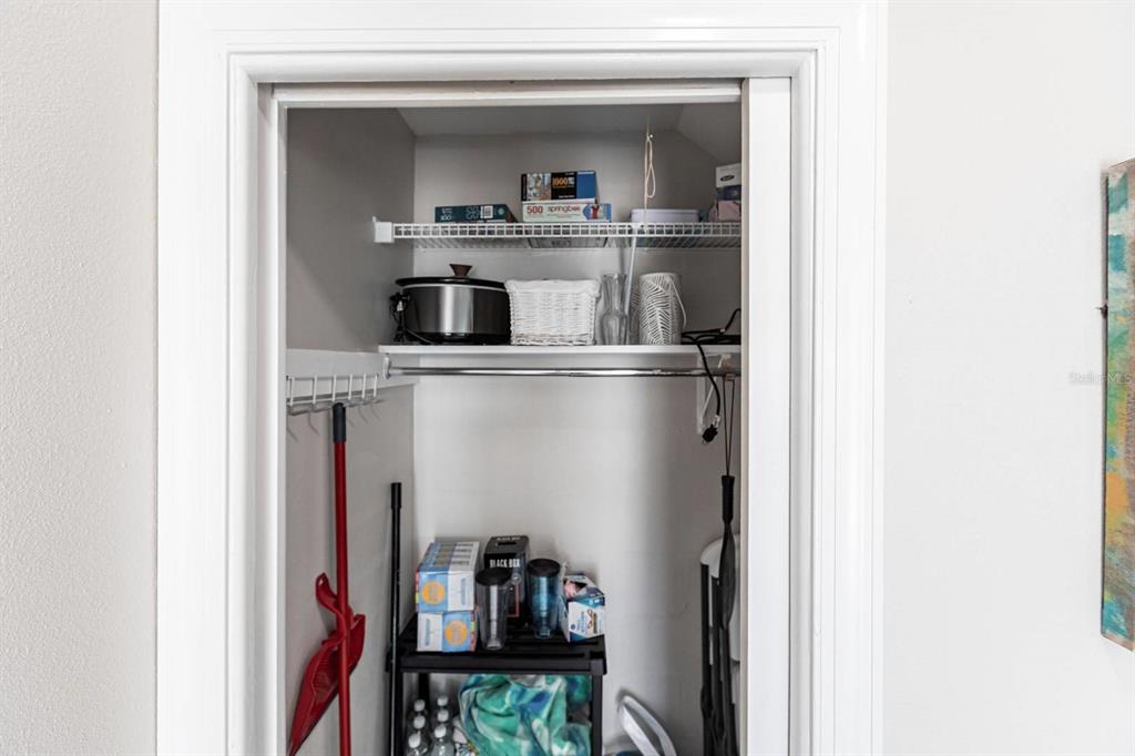 6020 Midnight Pass Road, Unit 52A Sarasota, FL 34242 - Photo 25 of 28 a living room with a bed and a book shelf