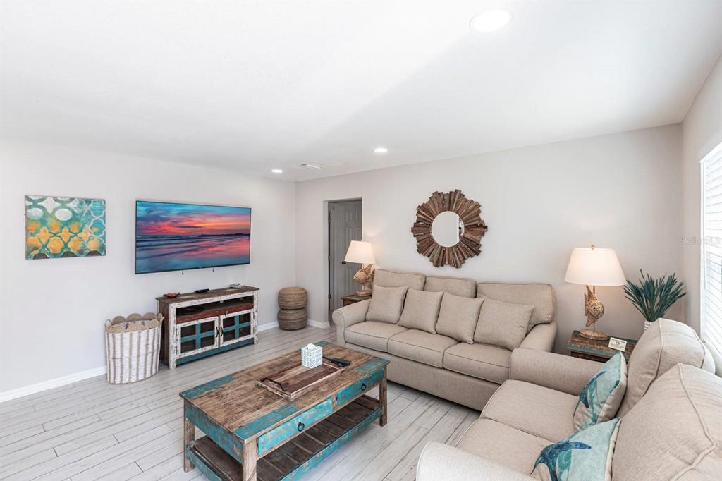 6020 Midnight Pass Road, Unit 52A Sarasota, FL 34242 - Photo 5 of 28 a living room with furniture and a flat screen tv
