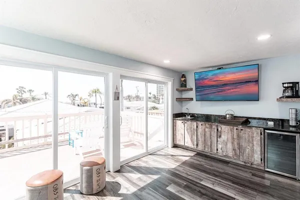 a living room with furniture a flat screen tv and a floor to ceiling window