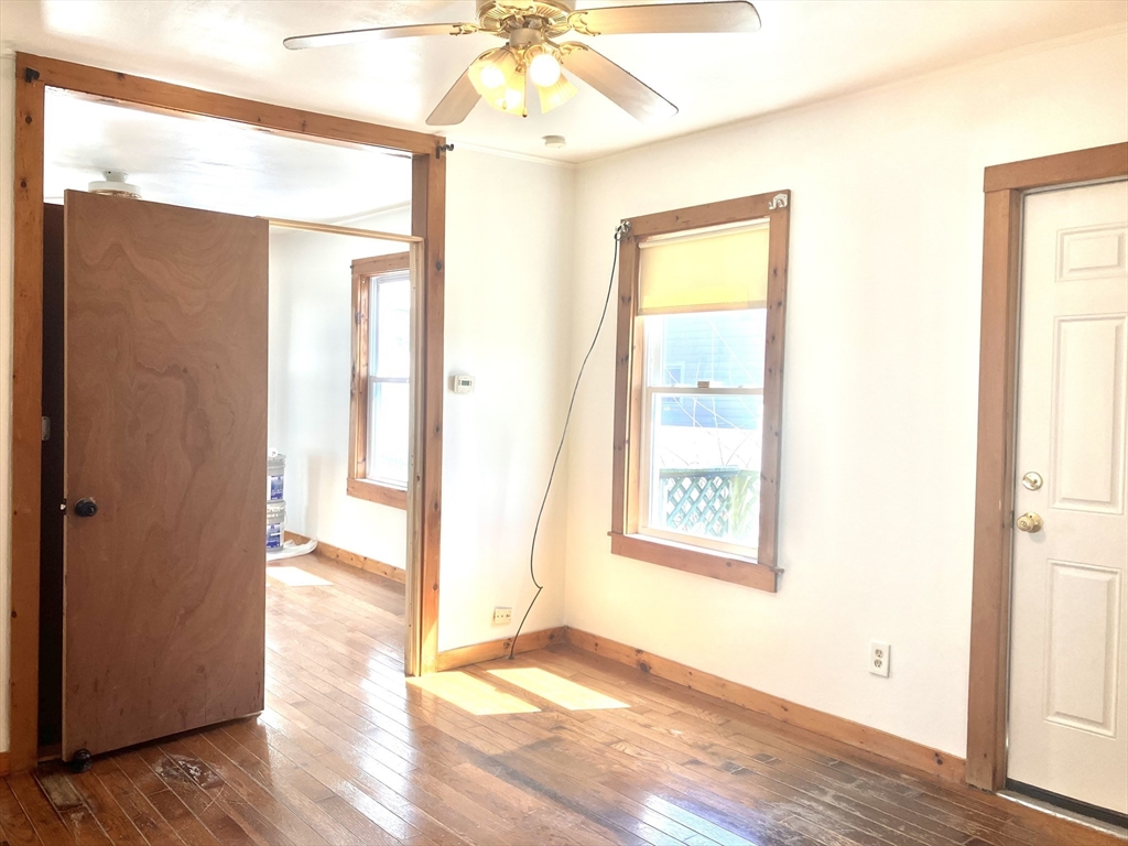 4 Sisson Terrace, Unit 1 Lynn, MA 01902 - Photo 9 of 16 a view of an empty room with wooden floor and a window