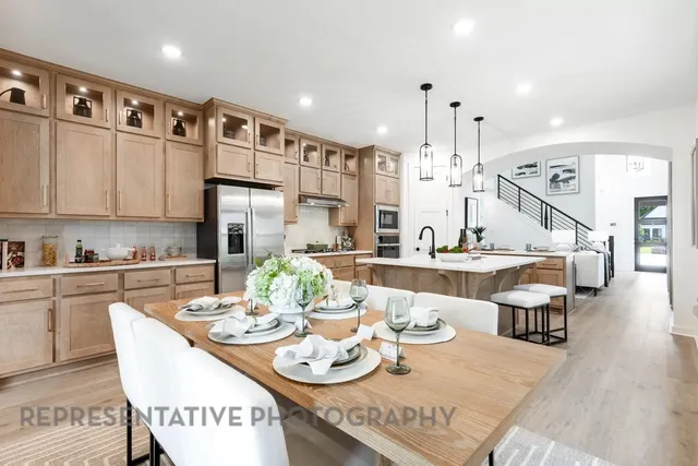 a large kitchen with a table and chairs