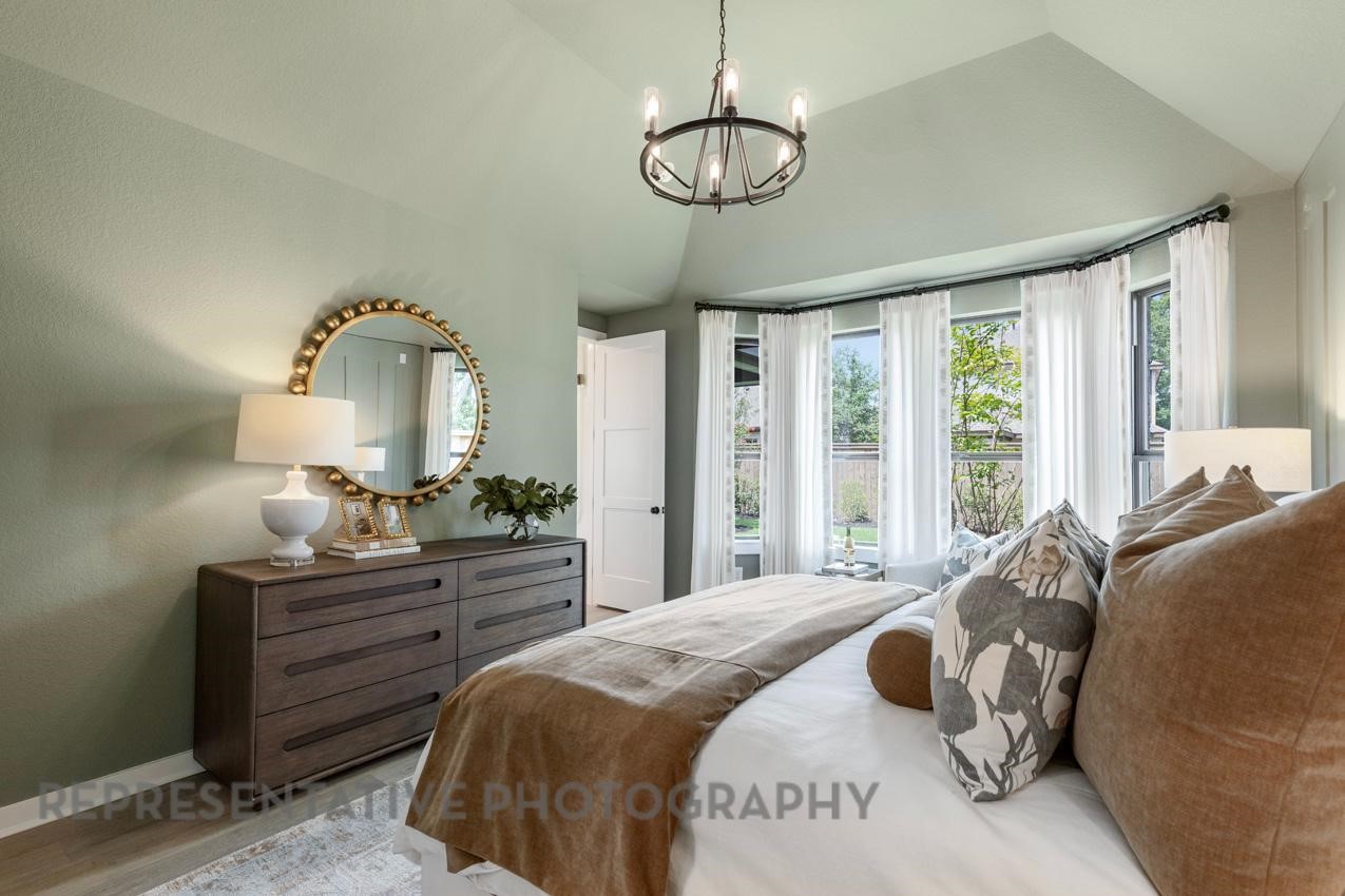 5310 Murillo Drive Manvel, TX 77578 - Photo 8 of 20 a bedroom with a bed and a chandelier