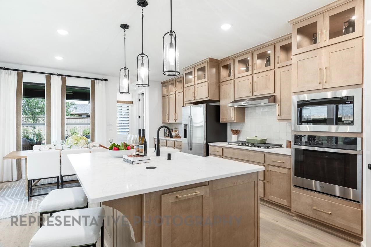 5310 Murillo Drive Manvel, TX 77578 - Photo 9 of 20 a kitchen with stainless steel appliances kitchen island granite countertop a sink and a refrigerator