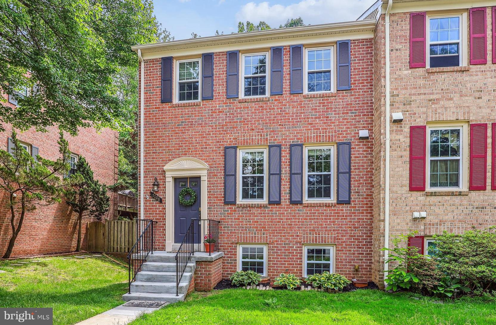 7708 Shootingstar Drive Springfield, VA 22152 - Photo 2 of 62 a front view of a brick house with a yard