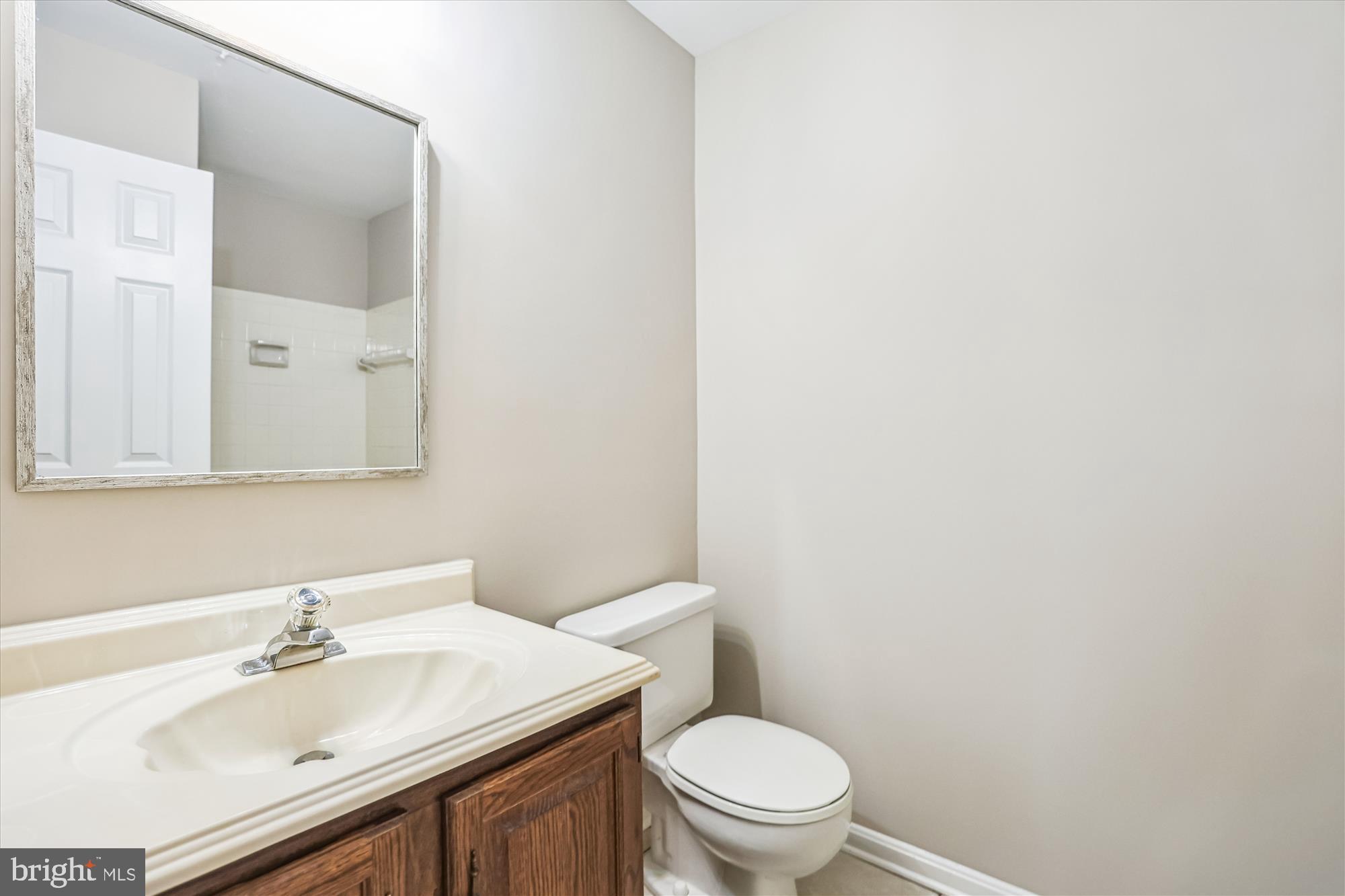 7708 Shootingstar Drive Springfield, VA 22152 - Photo 41 of 62 a bathroom with a sink a toilet and mirror