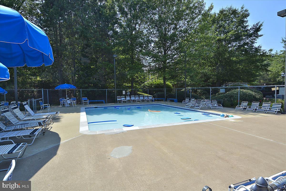 7708 Shootingstar Drive Springfield, VA 22152 - Photo 53 of 62 a view of a swimming pool with sitting area and furniture