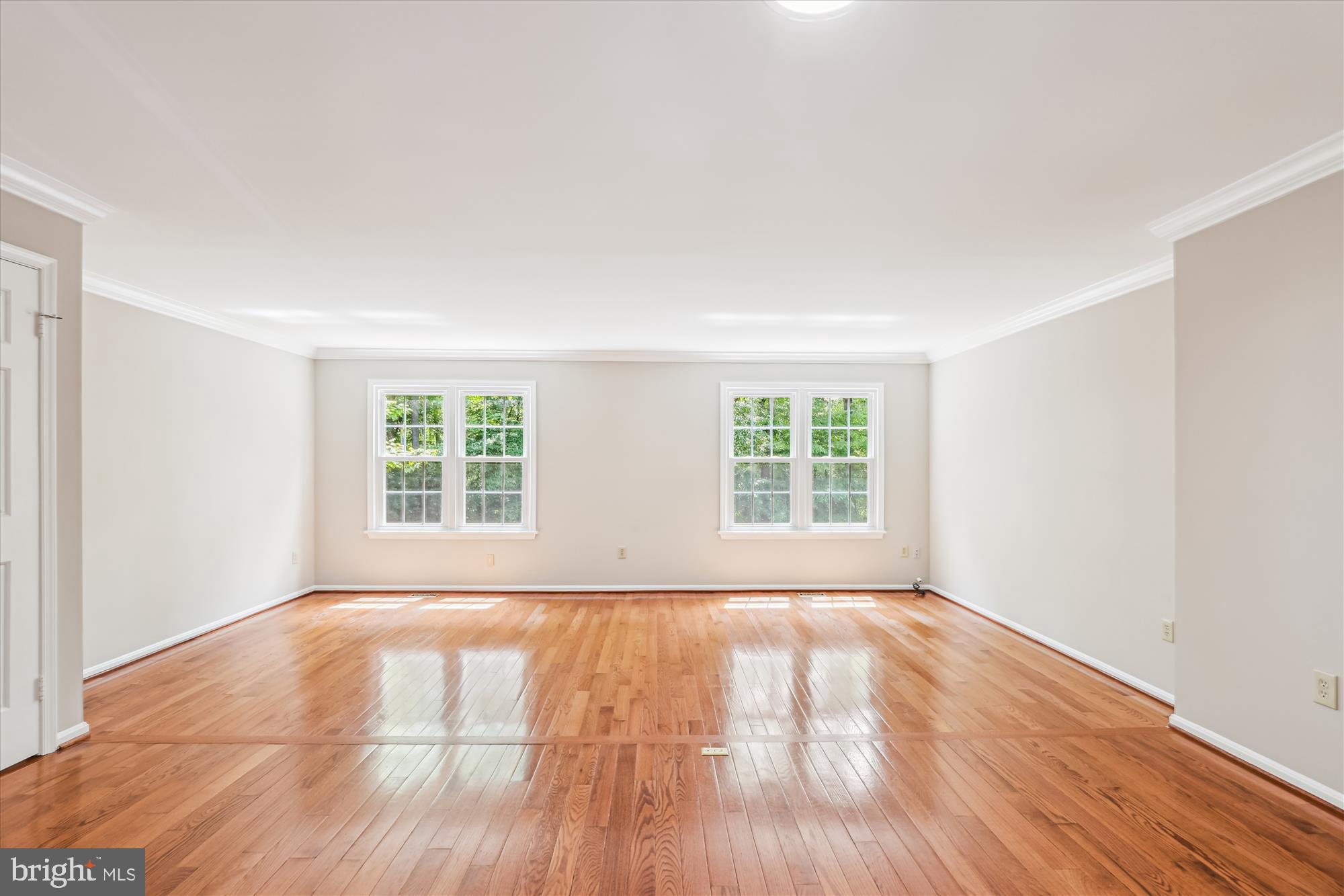 7708 Shootingstar Drive Springfield, VA 22152 - Photo 7 of 62 a view of an empty room with wooden floor and a window