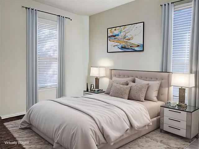 a bedroom with a bed and a painting on the wall