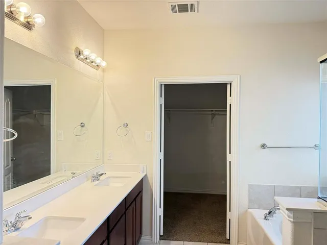 a en suite bathroom with a sink a toilet and shower