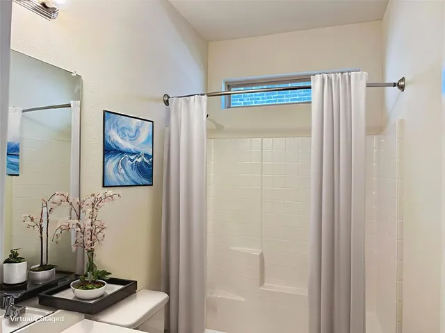 a bathroom with a shower and a sink