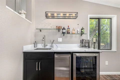 a kitchen with granite countertop a sink and cabinets