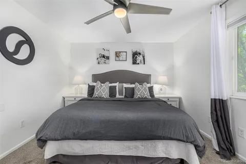 a bedroom with a bed and dresser with mirror