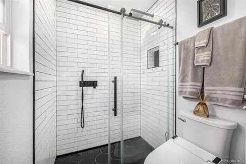 a bathroom with a toilet and a shower