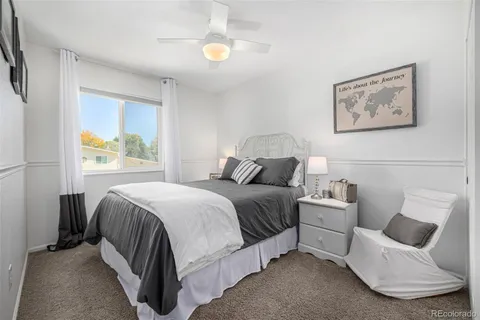 a bedroom with a bed and painting on the wall