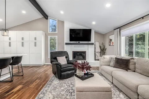 a living room with furniture fireplace and a flat screen tv