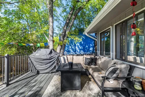 a view of a patio with couches table and chairs and potted plants
