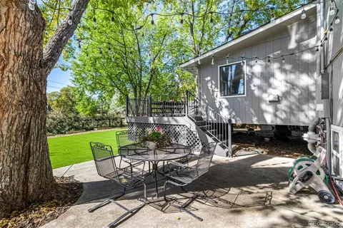 a view of backyard with outdoor seating and plants