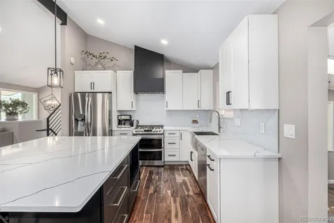 a kitchen with cabinets and a stove