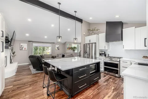 a large kitchen with a table and chairs