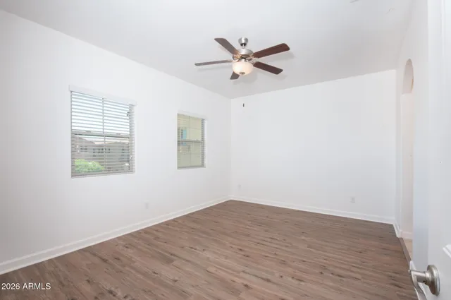 a view of a big room with wooden floor closet and windows