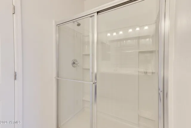 a bathroom with a glass shower door