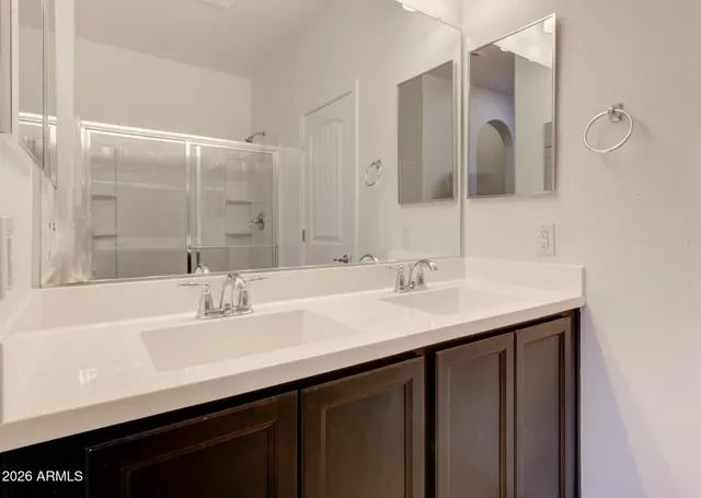 a bathroom with a sink double vanity and a mirror