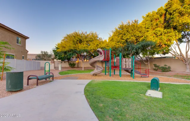 a view of a swimming pool with a lawn chairs and plants
