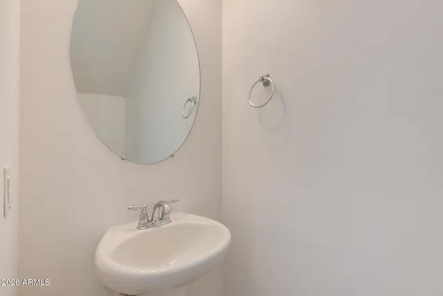 a bathroom with a sink and mirror