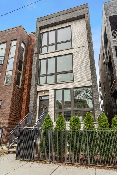 2437 West Haddon Avenue, Unit 2 Chicago, IL 60622 - Photo 1 of 14 a view of a brick building next to a yard