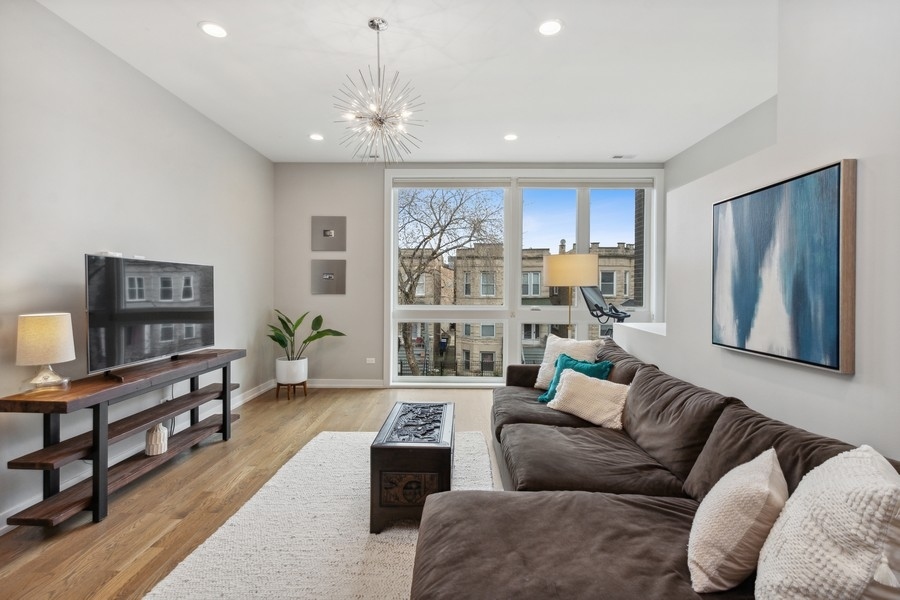 2437 West Haddon Avenue, Unit 2 Chicago, IL 60622 - Photo 2 of 14 a living room with furniture and a large window