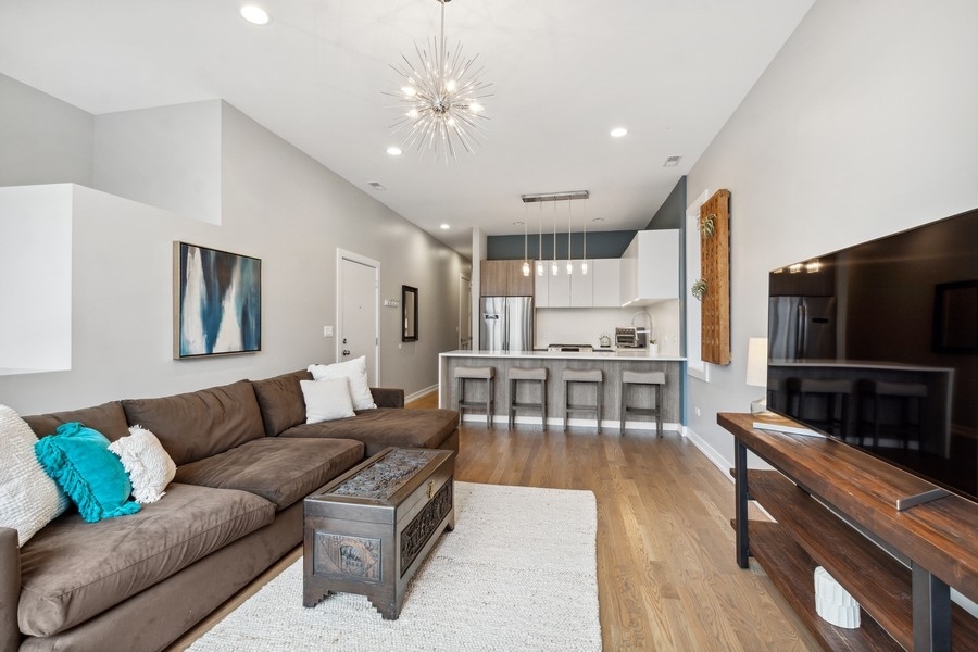 2437 West Haddon Avenue, Unit 2 Chicago, IL 60622 - Photo 4 of 14 a living room with furniture and a flat screen tv