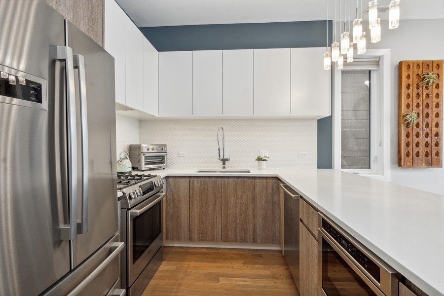 2437 West Haddon Avenue, Unit 2 Chicago, IL 60622 - Photo 6 of 14 a kitchen with stainless steel appliances a refrigerator sink and stove