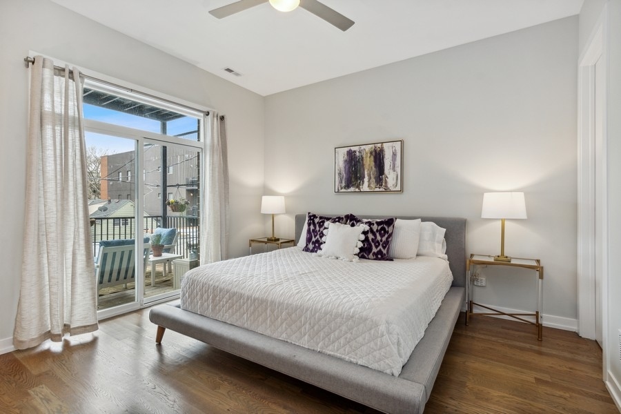 2437 West Haddon Avenue, Unit 2 Chicago, IL 60622 - Photo 8 of 14 a bedroom with a large bed and a night stand