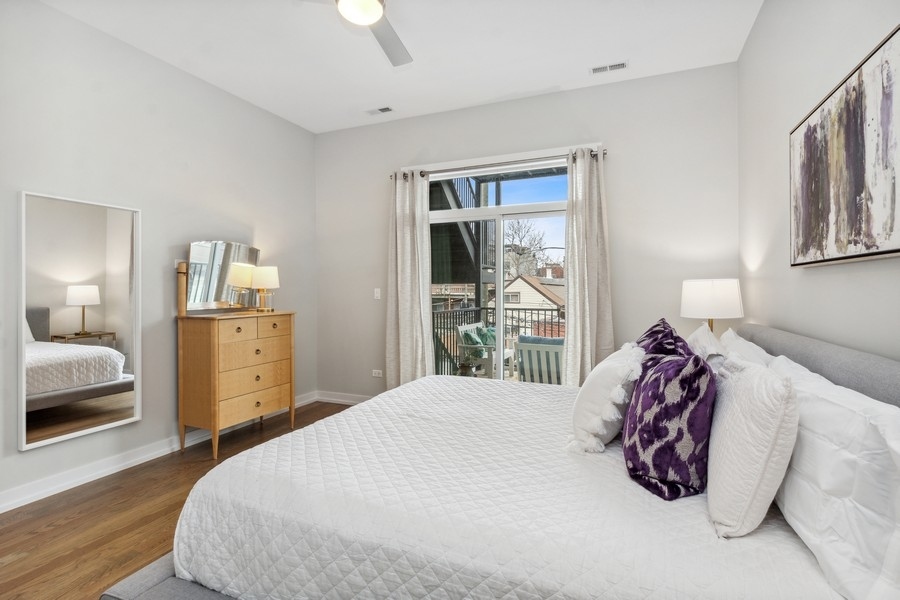 2437 West Haddon Avenue, Unit 2 Chicago, IL 60622 - Photo 9 of 14 a bedroom with a large bed and dresser