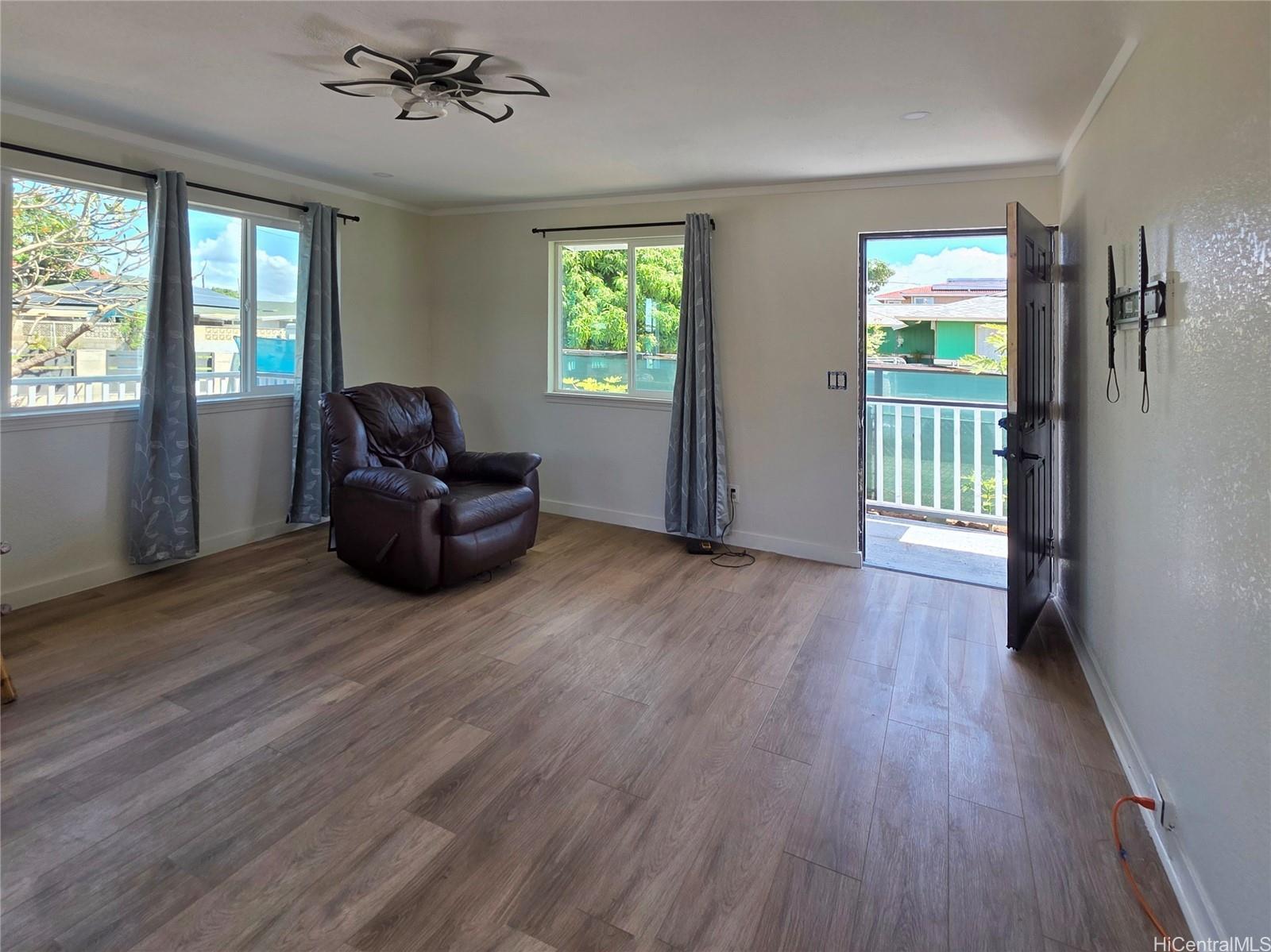 91-669 Pohakupuna Road Ewa Beach, HI 96706 - Photo 5 of 15 a living room with furniture and a wooden floor