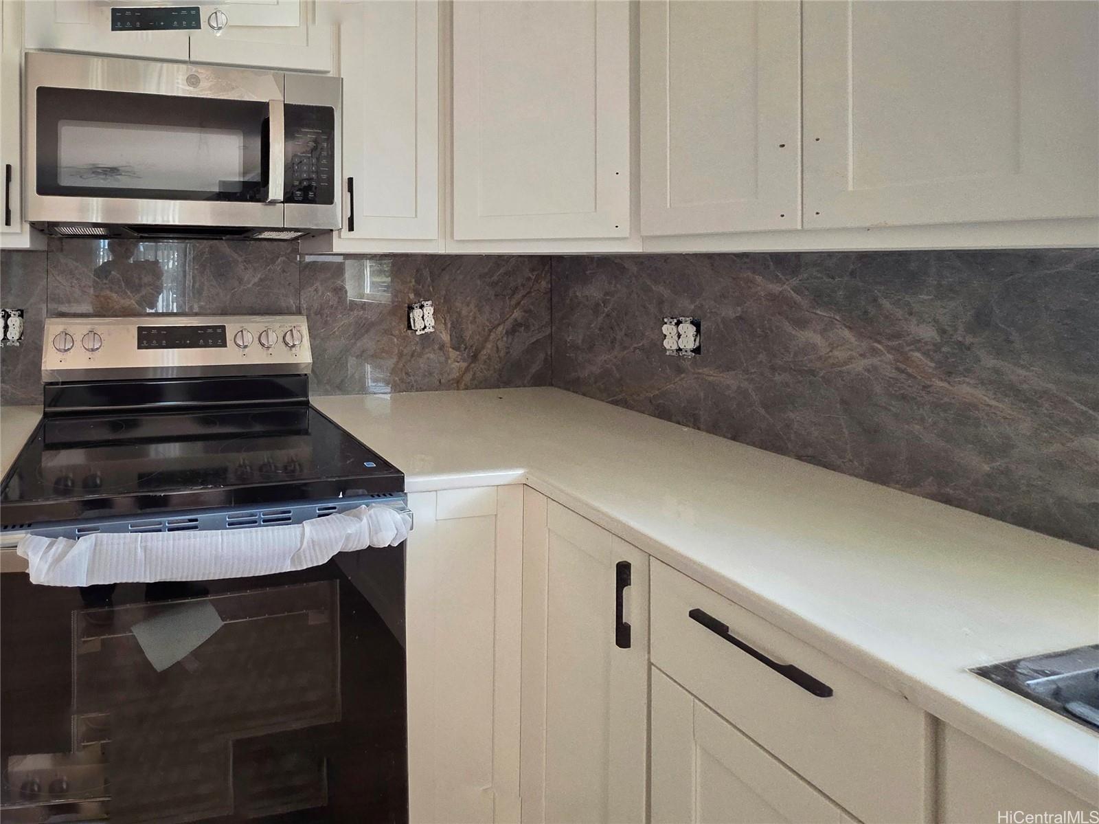 91-669 Pohakupuna Road Ewa Beach, HI 96706 - Photo 6 of 15 a kitchen with a stove and a microwave