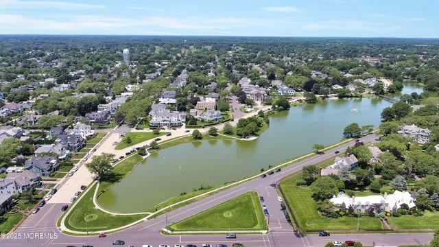 an aerial view of a residential houses with outdoor space and river