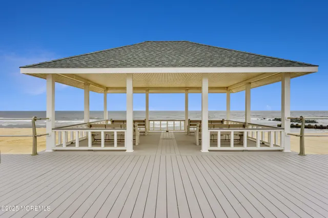 an outdoor view with a large swimming pool and sitting area