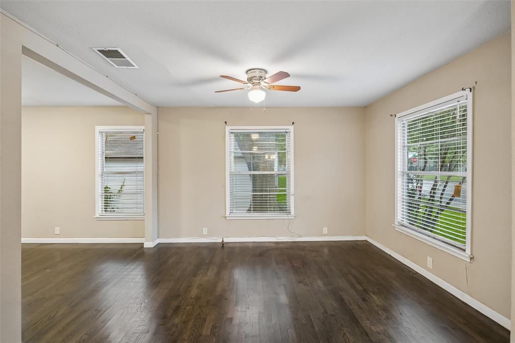 117 Moon Street Cleburne, TX 76033 - Photo 5 of 28 a view of an empty room with wooden floor and a window
