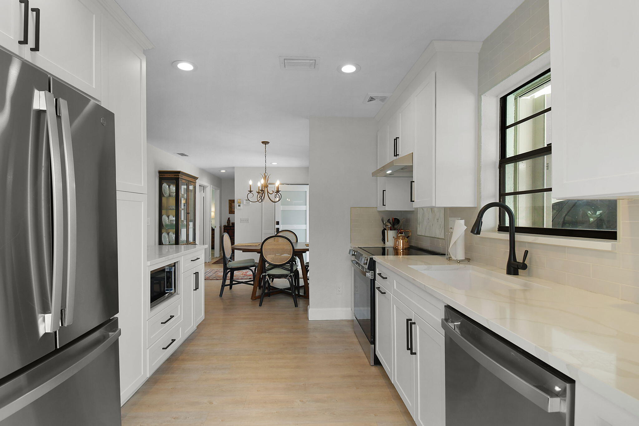 5251 Southeast Sea Island Way Stuart, FL 34997 - Photo 12 of 68 a kitchen with stainless steel appliances a stove a sink and a refrigerator