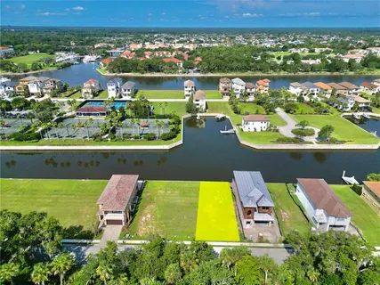 an aerial view of a house with a swimming pool lake view and mountain view