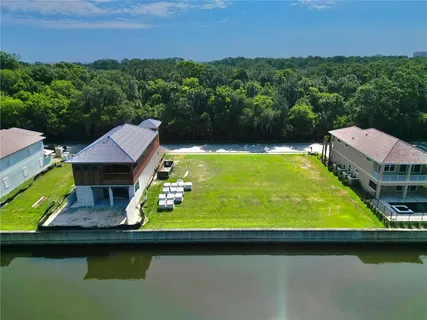 a view of a swimming pool with lawn chairs under an umbrella